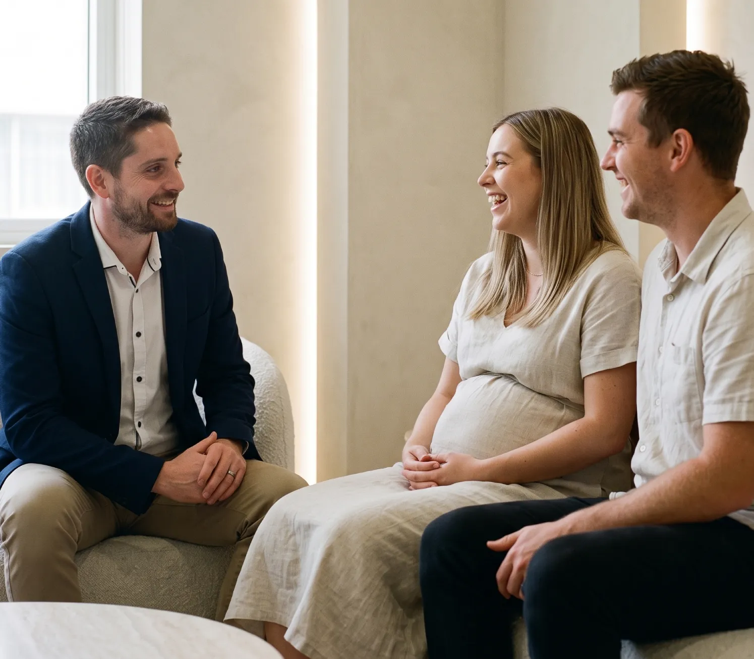 A candid photo of financial planner Jonathon De Martini, from DeMar Financial Planning, consulting with a young pregnant couple based in Middle Park